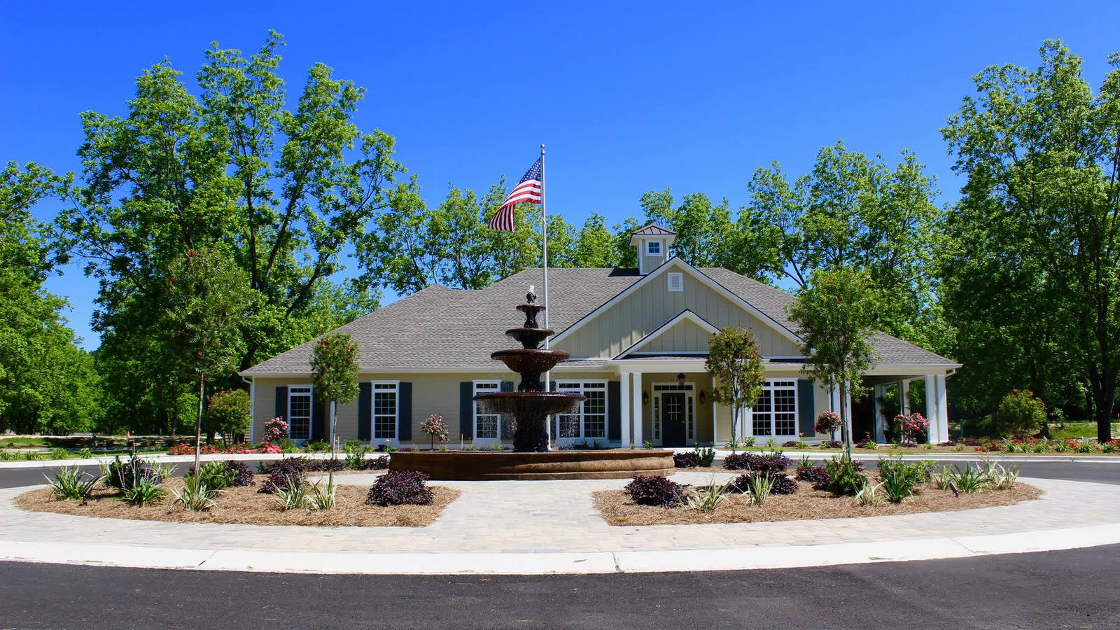 The clubhouse at The Orchard at Stone Creek, with its fountain and pecan trees, in Hahira GA